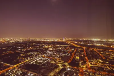 an aerial view of a city at night at Downtown Chic 2 Bedroom Apartment I Dubai Mall Access I Views of Burj Khalifa from Pool I Free Parking, Gym, Pool & Wi-Fi I by Meerak in Dubai