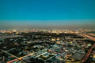 an aerial view of a city at night at Downtown Chic 2 Bedroom Apartment I Dubai Mall Access I Views of Burj Khalifa from Pool I Free Parking, Gym, Pool & Wi-Fi I by Meerak in Dubai