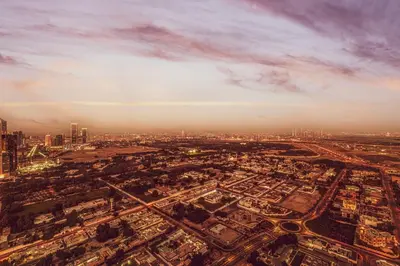 an aerial view of a city at sunset at Downtown Chic 2 Bedroom Apartment I Dubai Mall Access I Views of Burj Khalifa from Pool I Free Parking, Gym, Pool & Wi-Fi I by Meerak in Dubai