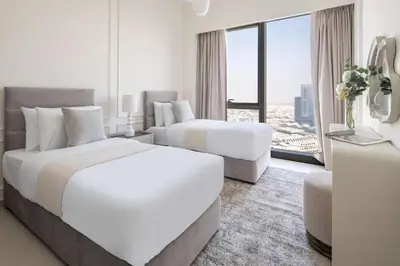 a hotel room with two beds and a large window at Frank Porter - Grande Signature Residences in Dubai