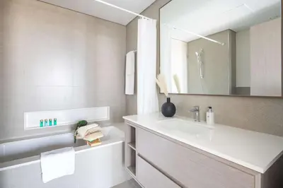 a bathroom with a sink and a mirror at Frank Porter - Grande Signature Residences in Dubai