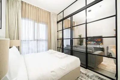 a bedroom with a white bed and a large window at SettlerHomes - Idyllic Dubai Hills Stay Near Parkside in Dubai