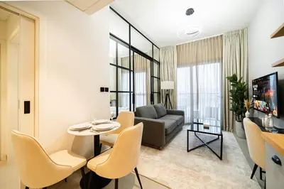 a living room with a couch and a table and chairs at SettlerHomes - Idyllic Dubai Hills Stay Near Parkside in Dubai