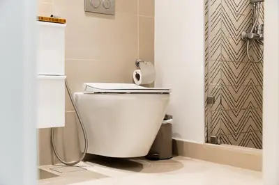 a white toilet in a bathroom with a shower at SettlerHomes - Idyllic Dubai Hills Stay Near Parkside in Dubai