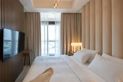 a bedroom with a large bed and a television at Keyrock Living - Luxury Stay in Business Bay in Dubai