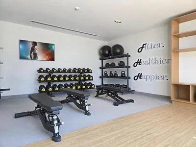 a fitness room with a gym with dumbbells and weights at Near Burj Khalifa, Dubai Fountain, Dubai Mall in Downtown in Dubai