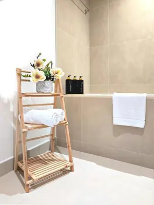 a bathroom with a bamboo towel rack and a bathtub at Near Burj Khalifa, Dubai Fountain, Dubai Mall in Downtown in Dubai