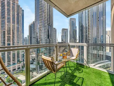 a balcony with a table and chairs and a view of the city at WonderfulStay at The Residences - Best Burj Khalifa & Fountain View - Brand New Luxury Apartments in Dubai