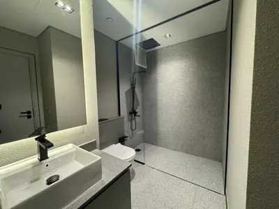 a bathroom with a sink and a toilet and a mirror at Brand New Designer 1-Bedroom Apartment With Free Parking in Dubai