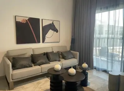a living room with a couch and a horse picture at Brand New Designer 1-Bedroom Apartment With Free Parking in Dubai