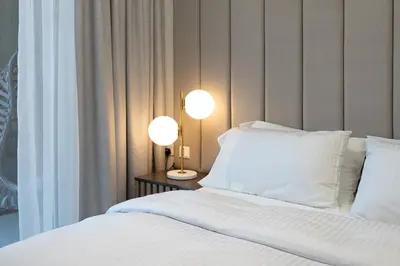 a bedroom with a bed with two lamps on it at KeyRock Elegant Aykon Apartment with City Views in Dubai