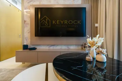 a living room with a tv and a table at KeyRock Elegant Aykon Apartment with City Views in Dubai