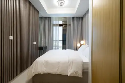 a bedroom with a white bed and a window at KeyRock Elegant Aykon Apartment with City Views in Dubai