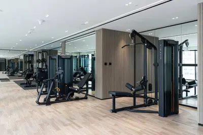a gym with treadmills and ellipticals in a building at Cozy 1br Apartment In Jvc Free Parking & Pool in Dubai