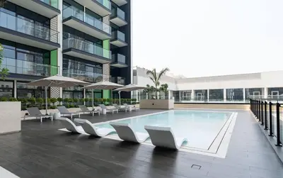 a swimming pool in the middle of a building at Cozy 1br Apartment In Jvc Free Parking & Pool in Dubai