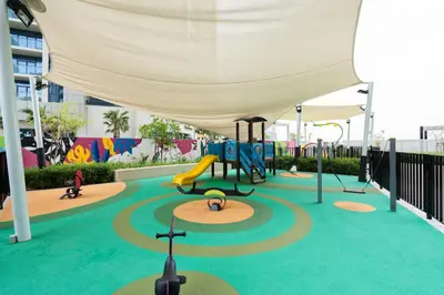 a playground with a slide and a play structure at Keyrock Living - Luxe 2BR in Business Bay in Dubai