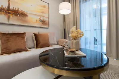 a living room with a couch and a glass table at Keyrock Living - Luxe 2BR in Business Bay in Dubai