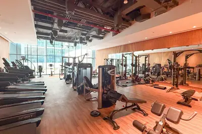 a gym with several treadmills and exercise bikes at Seafront Escape Infinity Pool & Private Beach in Dubai