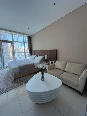 a living room with a bed and a couch and a table at Seafront Escape Infinity Pool & Private Beach in Dubai