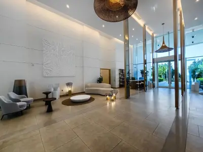 a lobby with a couch and a table and chairs at Sea-view 2BD apt with private beach in La Vie in Dubai