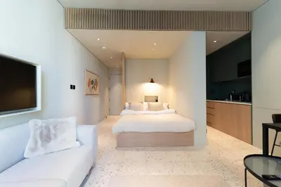 a bedroom with a white bed and a couch at Upside living business bay best in Dubai