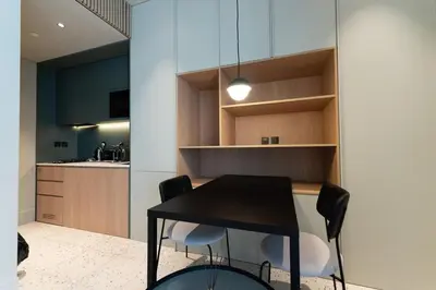 a kitchen with a black table and two chairs at Upside living business bay best in Dubai