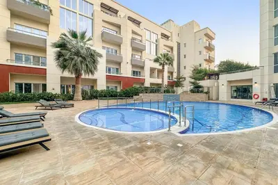 a swimming pool in the middle of a building at Pool View 1BR in Dubai Free Parking Gym Near Parks and Golf in Dubai