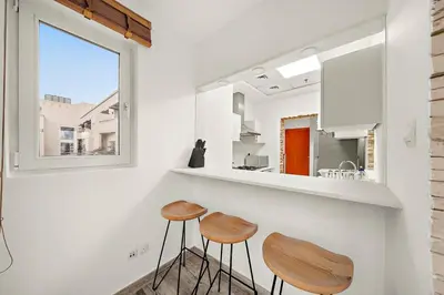 two stools in a kitchen with a mirror at Pool View 1BR in Dubai Free Parking Gym Near Parks and Golf in Dubai