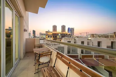 a balcony with chairs and a view of the city at Pool View 1BR in Dubai Free Parking Gym Near Parks and Golf in Dubai