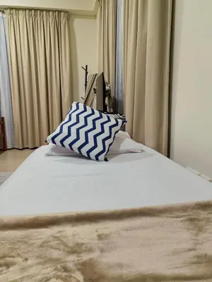 a bed with a blue and white pillow on it at Ahlan Premium Spacious Luxury Furnished 2 Bedroom Apartment Marina Beach JBR for Families and Groups in Dubai