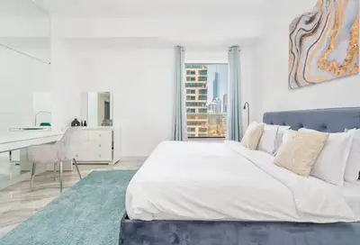 a white bedroom with a large bed and a desk at Ahlan Premium Spacious Luxury Furnished 2 Bedroom Apartment Marina Beach JBR for Families and Groups in Dubai