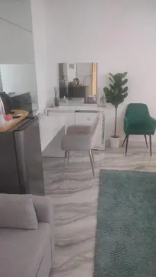 a living room with a couch and a green chair at Ahlan Premium Spacious Luxury Furnished 2 Bedroom Apartment Marina Beach JBR for Families and Groups in Dubai