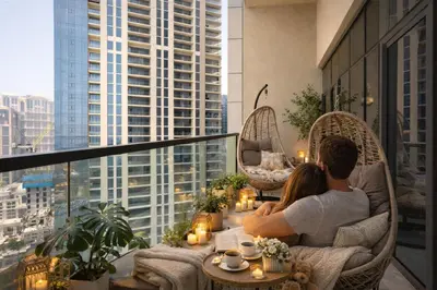 a man and a woman sitting on a balcony at KeyRock Luxury 2BR Apartment with City Views in Dubai
