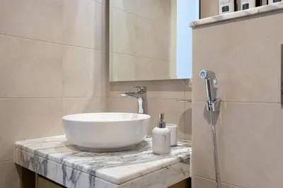 a bathroom with a white bowl sink on a counter at KeyRock Luxury 2BR Apartment with City Views in Dubai