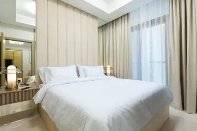 a bedroom with a large white bed and a window at Keyrock Living - Elevated Luxury in Business Bay in Dubai