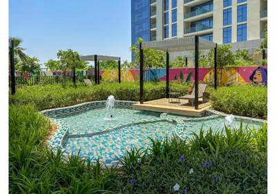 a small pool with a fountain in a park at Keyrock Living - Elevated Luxury in Business Bay in Dubai