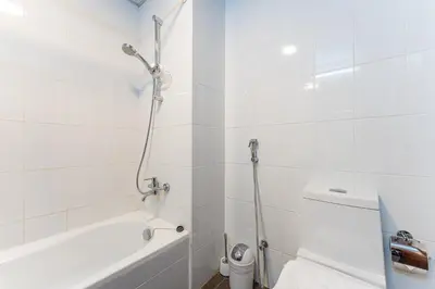 a bathroom with a shower and a tub and a toilet at HAVN - Studio in Downtown, 10mins to Dubai Mall in Dubai