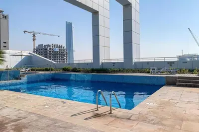 a swimming pool in a city with a building at HAVN - Studio in Downtown, 10mins to Dubai Mall in Dubai