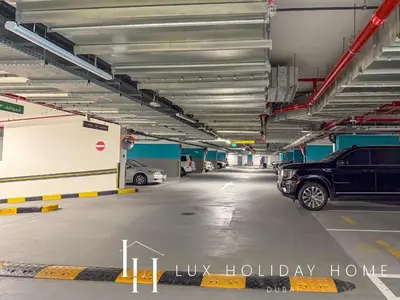 a parking garage with cars parked in it at LUX The Creek Palace Residence Suite in Dubai