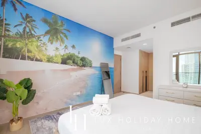 a bedroom with a beach mural on the wall at LUX The Creek Palace Residence Suite in Dubai