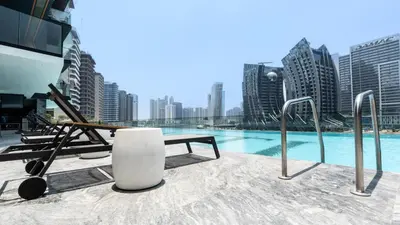 a view of a pool in a city with tall buildings at Keyrock Living - Binghatti Canal Luxury Stay in Dubai