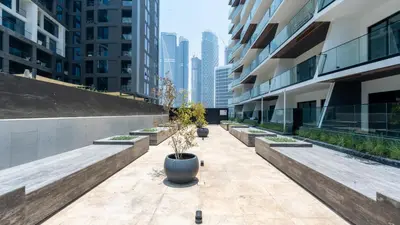 a courtyard in a building with potted plants at Keyrock Living - Binghatti Canal Luxury Stay in Dubai