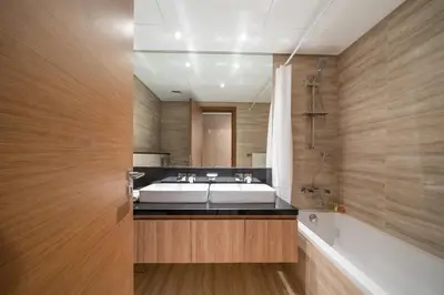 a bathroom with a white tub and a sink and a bath tubermott at Stylish 2BR Fully Furnished Unit at Business Bay in Dubai