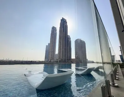 a group of white boats in the water with buildings at Stylish 2BR Fully Furnished Unit at Business Bay in Dubai