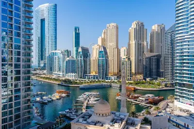 a view of a city with boats in a harbor at Luxury 3 bedroom with Stunning Full Marina View in Dubai in Dubai