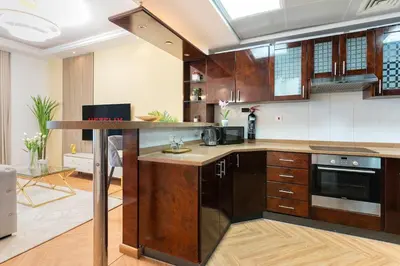 a kitchen with wooden cabinets and a counter top at Luxury 3 bedroom with Stunning Full Marina View in Dubai in Dubai