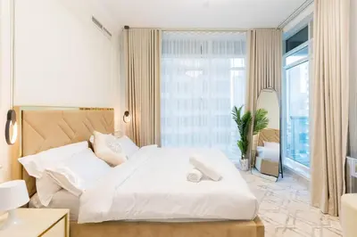 a bedroom with a white bed and a large window at Luxury 3 bedroom with Stunning Full Marina View in Dubai in Dubai