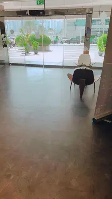 a room with a table and a surfboard on the floor at Panoramic Marina View in Dubai