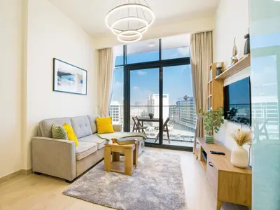 a living room with a couch and a large window at EasyGo- Splendid Apartments in Al Meydan Living in Dubai