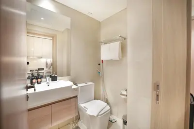 a white bathroom with a sink and a toilet at EasyGo- Splendid Apartments in Al Meydan Living in Dubai